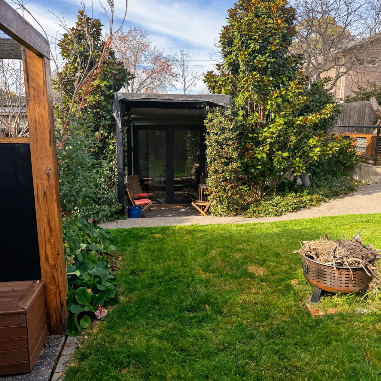 Garden lawn with a fire pit, looking back towards the studio's covered courtyard