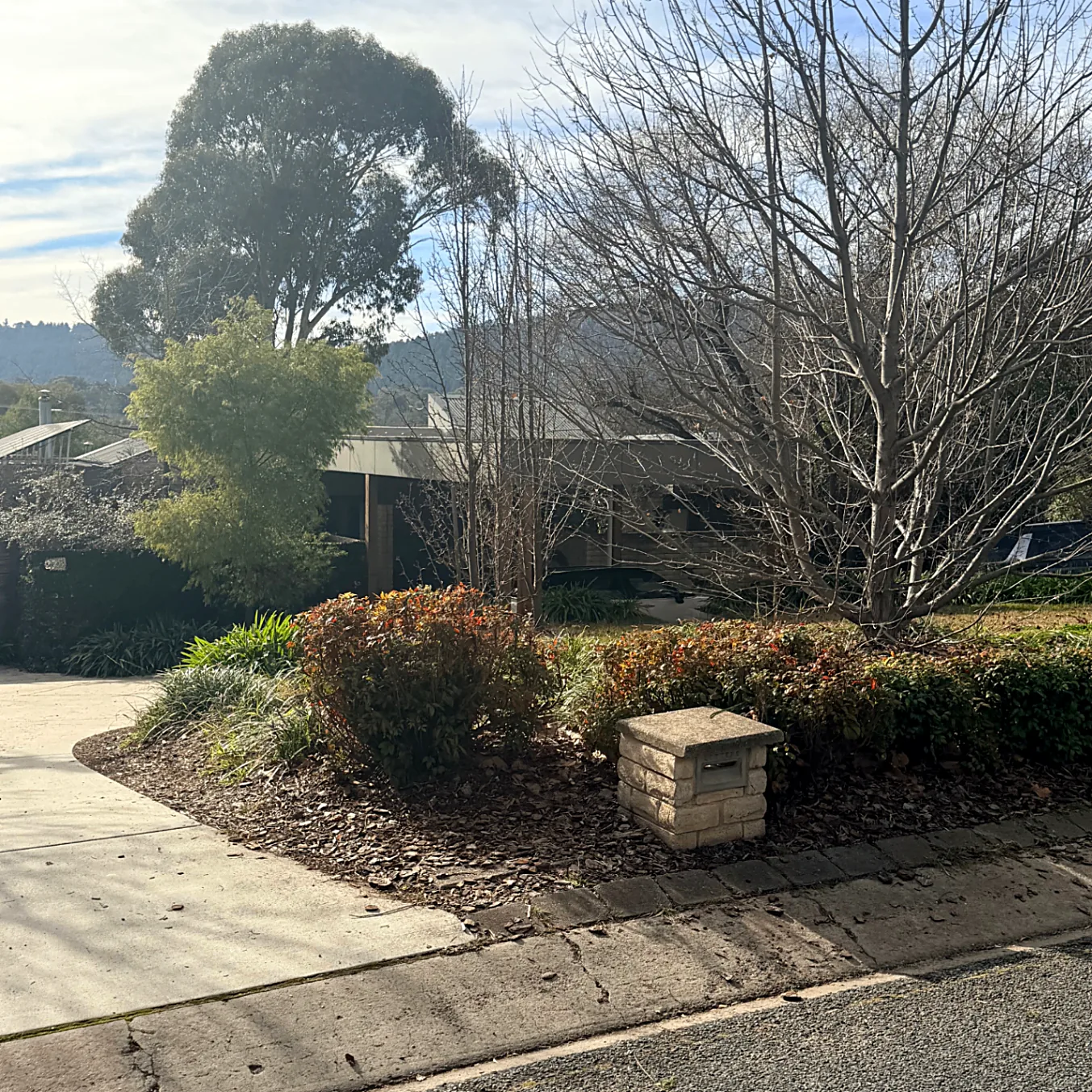 Street view of the main house, driveway and stone letterbox
